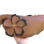 Leather clutch with flower applique..